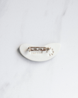 The back of the pin is bright white porcelain and features a "Detroit" stamp and a round, Pewabic logo stamp. The silver pin-back is glued onto the tiny pin tile.