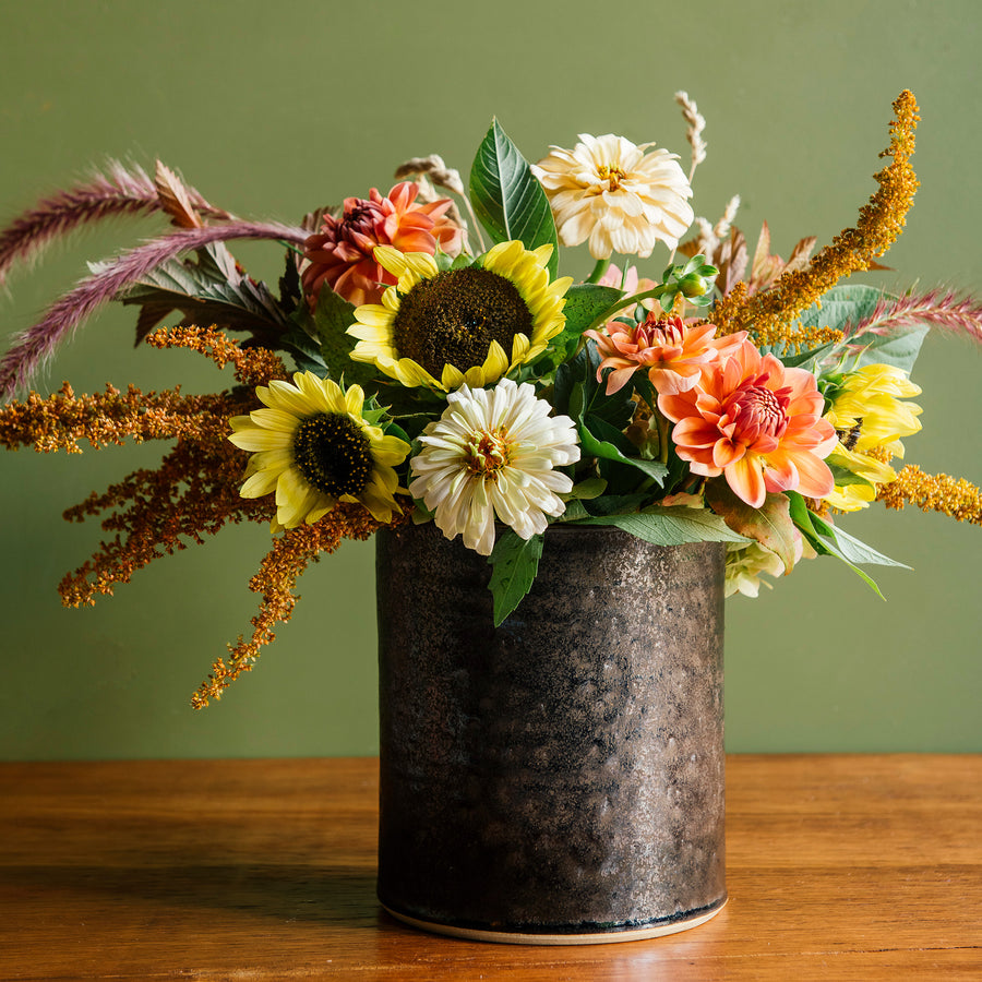 This Crock in the Graphite Glaze holds the last blooms of summer: sunflowers, dahlias and long, soft Bunny Tails. 