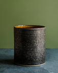 A close-up of the Graphite glaze shows its dappled surface - from shiny and smooth to more textured and metallic. The high variation found in this glaze is exemplified on the flat, vertical side of the Pewabic Crock.