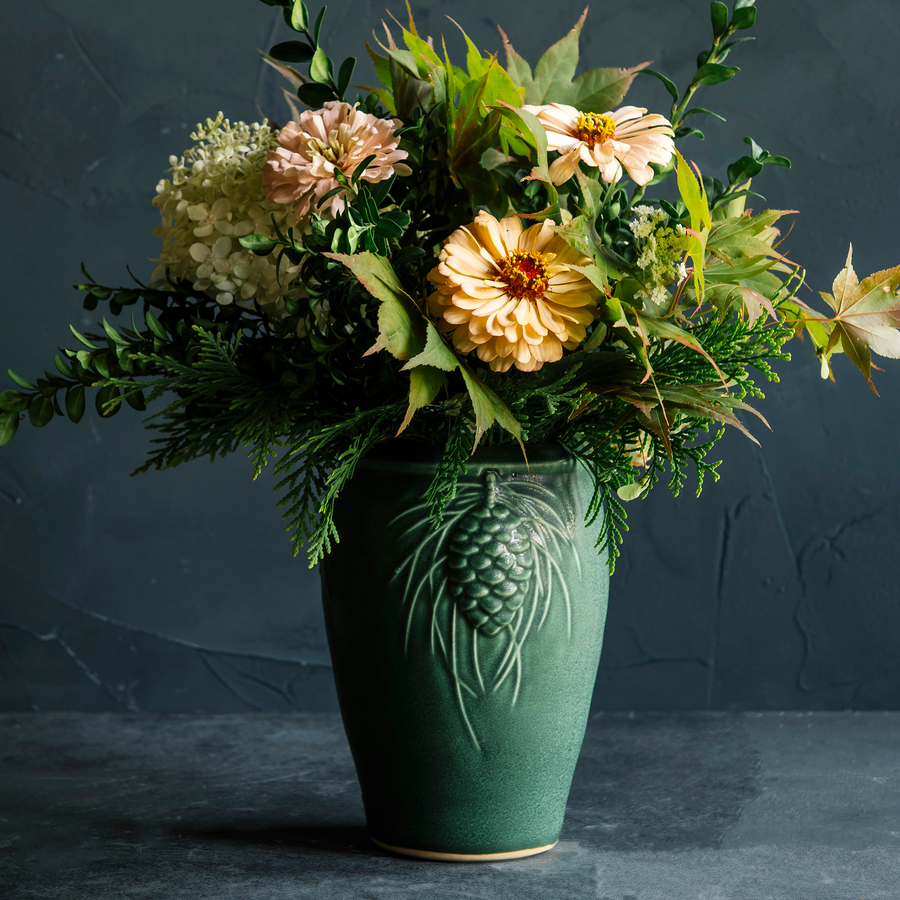 This Pinecone Vase features the semi-matte variable green Elm glaze.