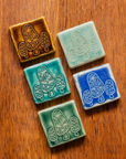 All four glaze types are represented in this image. Celadon, Pewabic Blue, Periwinkle, Molasses, and Emerald.