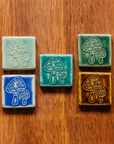 All four glaze types are represented in this image. Celadon, Pewabic Blue, Periwinkle, Molasses, and Emerald.