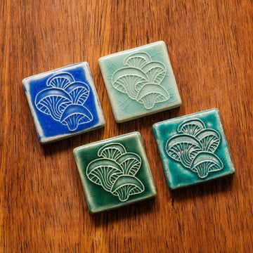 All four glaze types are represented in this image. Celadon, Pewabic Blue, Periwinkle, and Emerald.