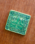 This tile features the matte blueish-green Pewabic Green glaze.