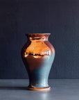 The Classic Vase starts with a small diameter at its base that gradually gets larger until it contracts again near the top with a slightly wider lip. The sides of this vase are completely smooth.