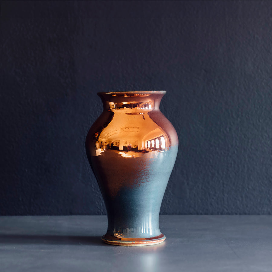 The Classic Vase starts with a small diameter at its base that gradually gets larger until it contracts again near the top with a slightly wider lip. The sides of this vase are completely smooth.