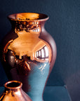 The Copper iridescent glaze is a shiny, smooth metallic glaze with many variations. Some pieces end up with a blue-gray flashing of color that covers a portion of the surface.