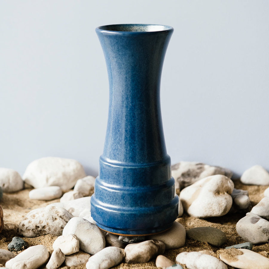 This Step Vase features the matte cornflower Leland Blue. This glaze can mix with the iron in the clay body to produce organic speckles of dark brown across the vase's surface.