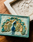 The hand painted Peacock rests on the historic mold from which it is taken.