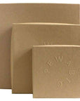 Three brown craft paper boxes are stacked together. Each has the word Pewabic embossed into the lid.